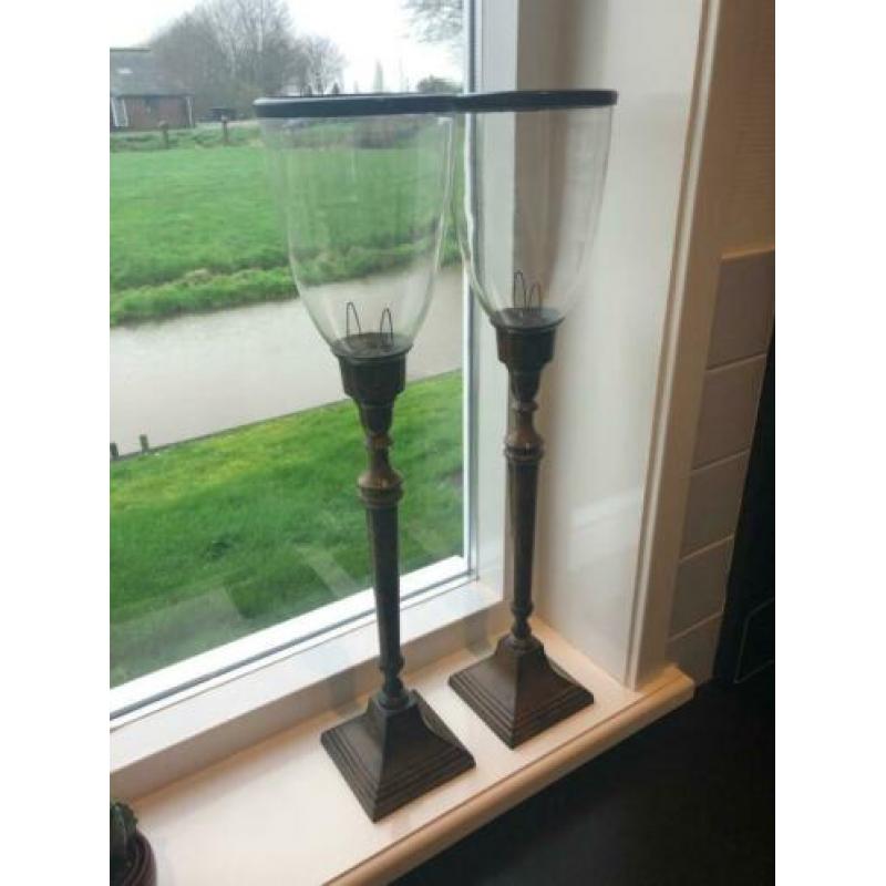 twee roestbruine kandelaren met windlicht